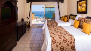 Una camera d'albergo con un letto, una TV, una scrivania e un balcone vista mare.