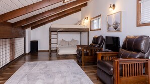 A loft bedroom with a bunk bed, wooden furniture, a television, and a framed picture on the wall. - NEW! Family Cabin Retreat in Munds Park w/ Cozy Back Patio & Loft (Sedona)