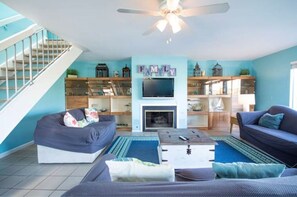 Relax in this stylish living room with a fireplace, flat-screen TV, and comfortable seating options.