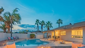 A swimming pool with a fire pit, outdoor seating, and palm trees. - Centrally Located Hike Dine & Shop w/ Pool Table, Heated Pool, Office, Firepit (Phoenix)
