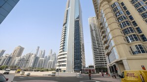 A modern high-rise building with a curved facade, surrounded by other tall buildings. - Spacious 2 BD in JLT with Marina Views (Dubai)