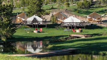 Cabins nestled among lush greenery, elevated on stilts for a unique view.