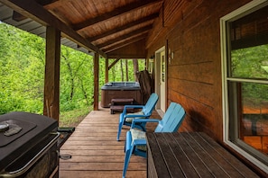 A wooden deck with a hot tub, two blue chairs, and a grill. - Liberty Belle: Budget friendly near Hocking River (Logan)