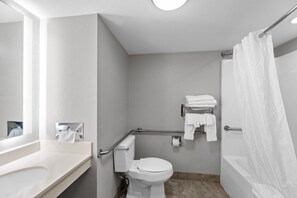 A bathroom with a white sink, toilet, and bathtub. - Starkville Inn and Suites (Starkville)