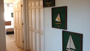 A hallway with a closed door, a ceiling vent, and three framed pictures on the wall. - A Bigger Catch Supply, NC ICW Best Fishing Hole In Brunswick County NC!!!! (Supply)