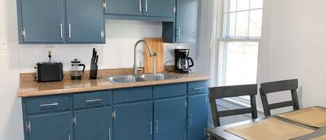 Fridge, coffee/tea maker, toaster, cookware/dishes/utensils