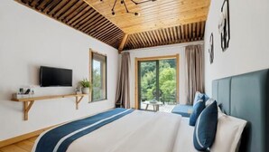 A bedroom with a bed, a TV, a window, and a balcony. - Mojia Inn (Deqing)