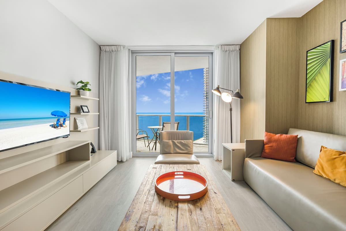 Luxury Apartment, 2 Bedrooms, Ocean View | Living area | 50-inch Smart TV with cable channels