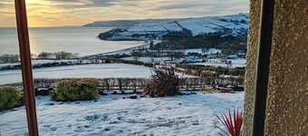 Traditional 5 bedroom house overlooking Cushendun bay. Pet friendly.