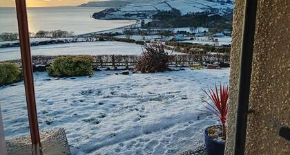 Traditional 5 bedroom house overlooking Cushendun bay. Pet friendly.