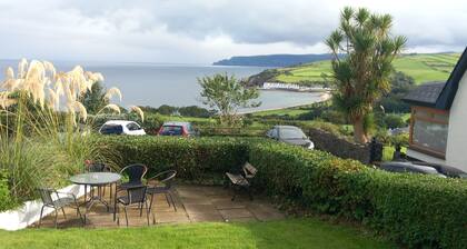 Traditional 5 bedroom house overlooking Cushendun bay. Pet friendly.