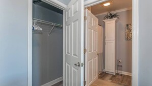 A hallway with a closet, a door, and a cabinet. - Cozy Resort - Pickleball, Beaches, Boat Ramps (Huddleston)