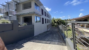 A modern two-story building with a flat roof and large windows. - Island Travelers Acccommodation (Suva)