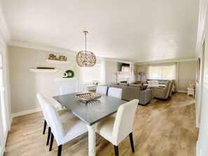 A modern interior with a dining area, a living room, and a kitchen.