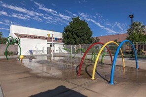 A water play area with colorful arches and a white building in the background. - Las Palmas Resort #909 | All-Inclusive Amenities (Saint George)
