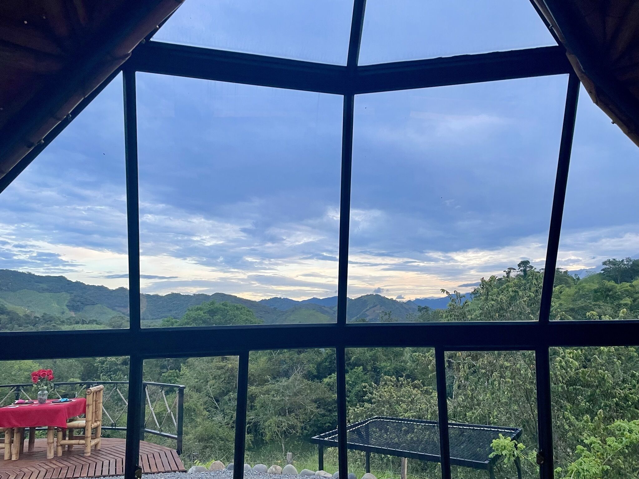 A view from a room with large windows overlooking a mountainous landscape.