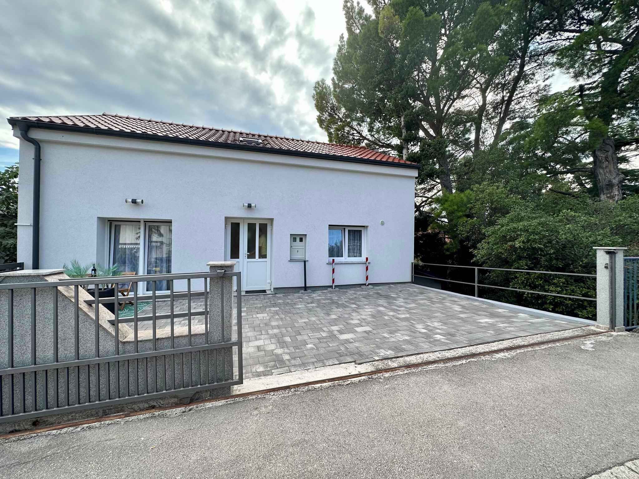 Ein modernes, zweistöckiges Gebäude mit flachem Dach und befestigter Auffahrt.