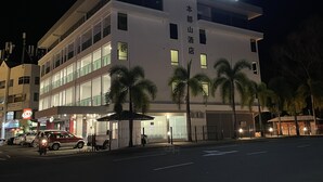 A modern hotel building with a sign reading "HOTEL BUNDUSAN" and "BUNDUSAN HOTEL" in large letters. - HOTEL BUNDUSAN (Kota Kinabalu)