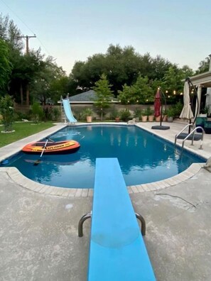 Relax by the pool surrounded by lush greenery and enjoy a refreshing swim.