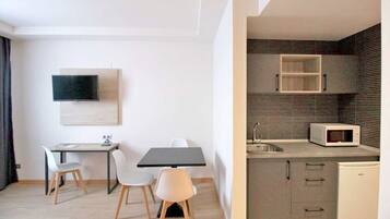 A modern kitchen with a microwave, sink, and cabinets.