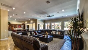 A spacious living room with a large sectional sofa, a coffee table, and a ceiling fan. - The Grand Resort, 1 Acre Property.
"Huge Outdoor Space to Relax in the Sun!" (gilbert)