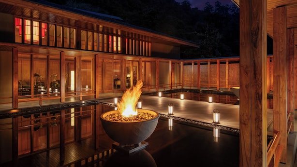 A wooden deck with a central fire feature, surrounded by lanterns and a view of the night sky. - Taj Guras Kutir Resort & Spa, Gangtok (Gangtok)