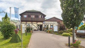 A building with a sign reading 'SaunaTherme, Heiber' and a paved entrance. - Holiday Apartment "Harzblick" with Mountain View, Balcony & Wi-Fi (Altenau)