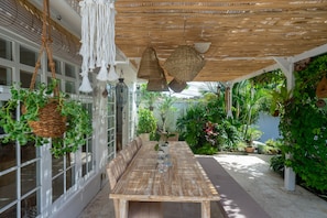 Enjoy a peaceful outdoor dining experience surrounded by lush greenery and natural beauty.