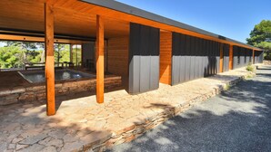 A modern building with a covered patio area, stone flooring, and a water feature. - Villa Vela Baraka with private Pool, Dragove, Croatia (Dragove)