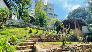 Un escalier en pierre mène à un bâtiment dont le toit est recouvert de chaume.