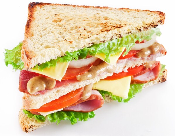 A sandwich with multiple layers of ingredients. - Parasol Inn Sikkim (Gangtok)