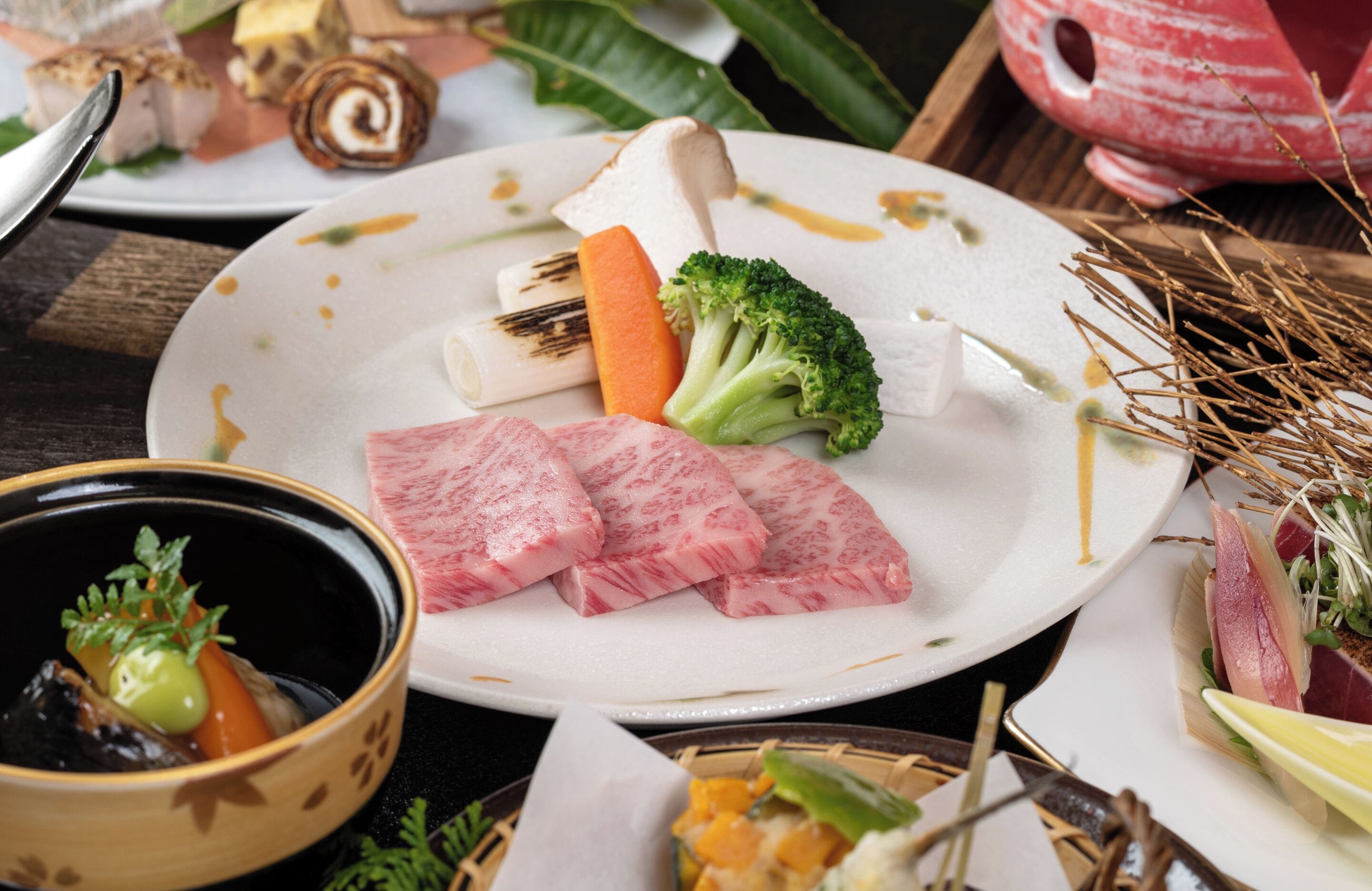 A plate with various food items including sliced meat, vegetables, and a roll.