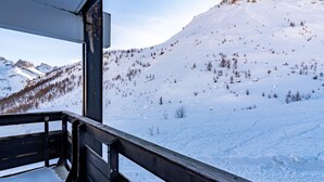 A snowy mountain landscape with a wooden balcony railing. - Home Club (Lavachet) by Interhome (Tignes)