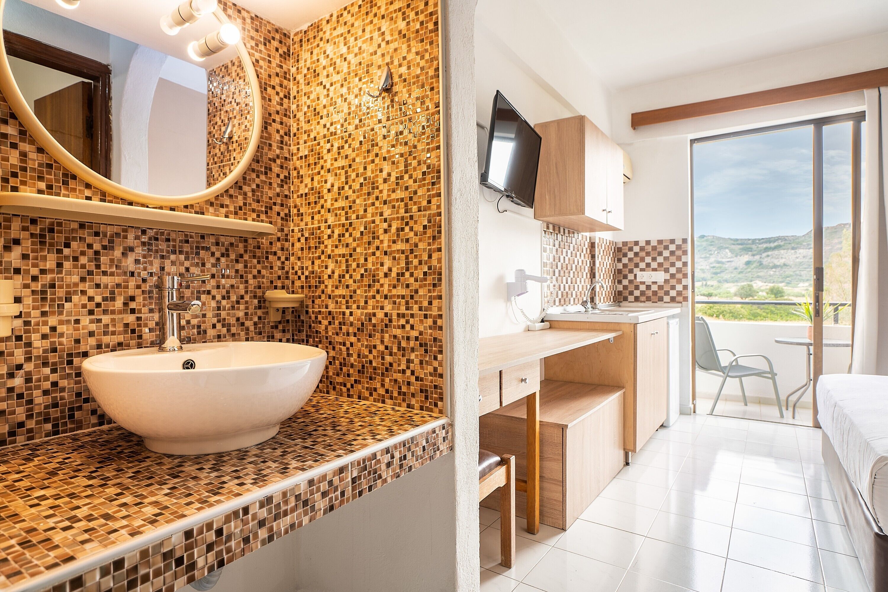 A bathroom with a mosaic tile wall, a sink, and a mirror.