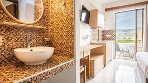 A bathroom with a mosaic tile wall, a sink, and a mirror.