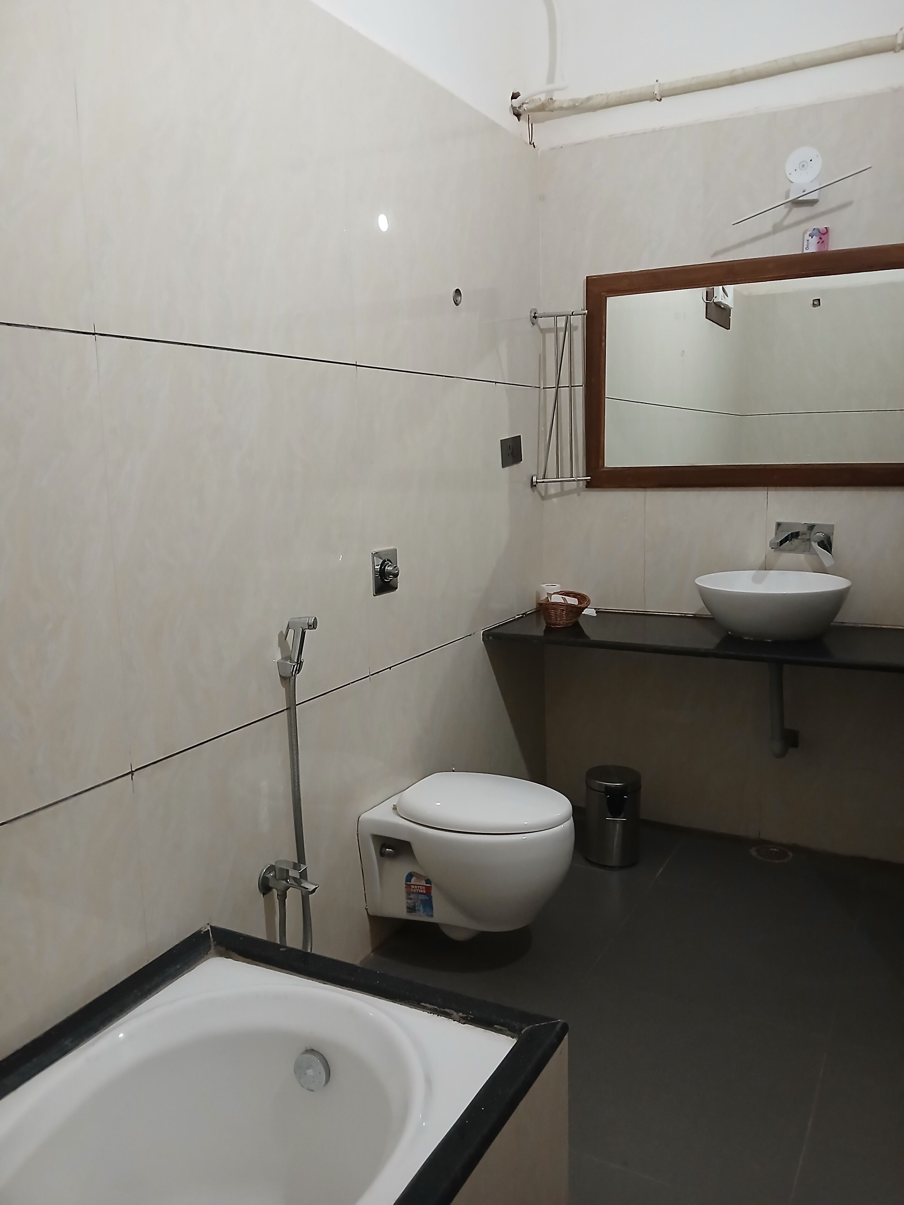 A modern bathroom with a white toilet, a sink, and a bathtub.
