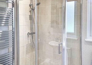 A glass-enclosed shower with a handheld showerhead and a wall-mounted faucet. - Rabbit Lodge is designed to provide you with a luxurious and comfortable stay. (Thorney, Nr Lincoln)