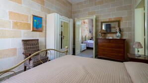 A bedroom with a bed, dresser, chair, and a door leading to another room. - 3450 Casa Maredoro by Barbarhouse (Nardò)