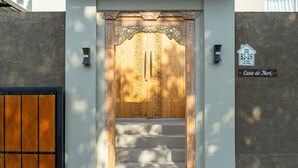A wooden door with intricate carvings and a sign above it reading "Casa de Nuri." - 3Bedroom Private Pool Villa Casa De Nuri (Jimbaran)