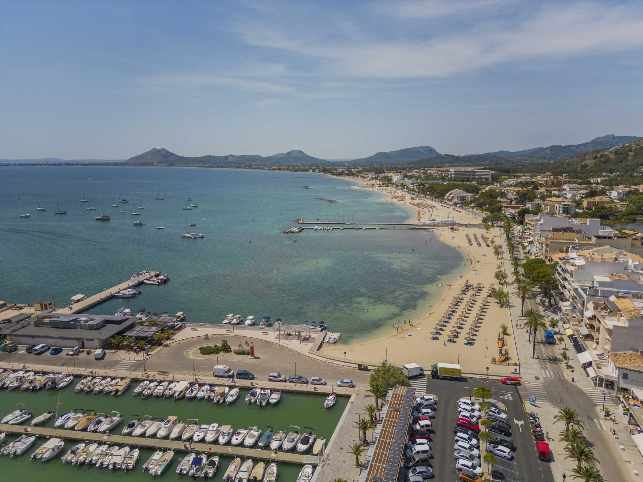 A coastal town with a marina, beach, and urban area.
