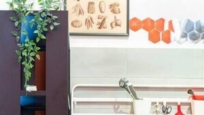 A compact laundry area with a front-loading washing machine and a stacked washer-dryer unit. - Central and cozy loft with courtyard (Bologna)