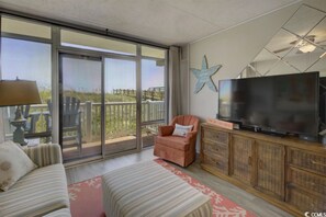 Signature Condo, 1 Bedroom, Balcony, Ocean View | Living room | 55-inch Smart TV with cable channels, books