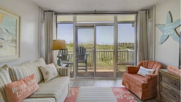 Signature Condo, 1 Bedroom, Balcony, Ocean View | Living room | 55-inch Smart TV with cable channels, books