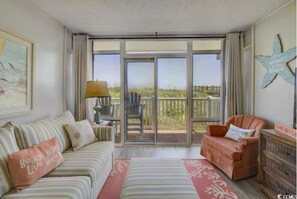 Signature Condo, 1 Bedroom, Balcony, Ocean View | Living room | 55-inch Smart TV with cable channels, books