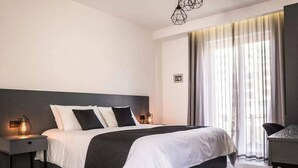 Ein modernes Schlafzimmer mit einem großen Bett, Nachttischen und einem Schreibtisch.