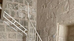 A staircase with a metal railing leading to a laundry area with a washing machine. - Serenity 2  studio apartment with small terrace (Ħal Qormi)