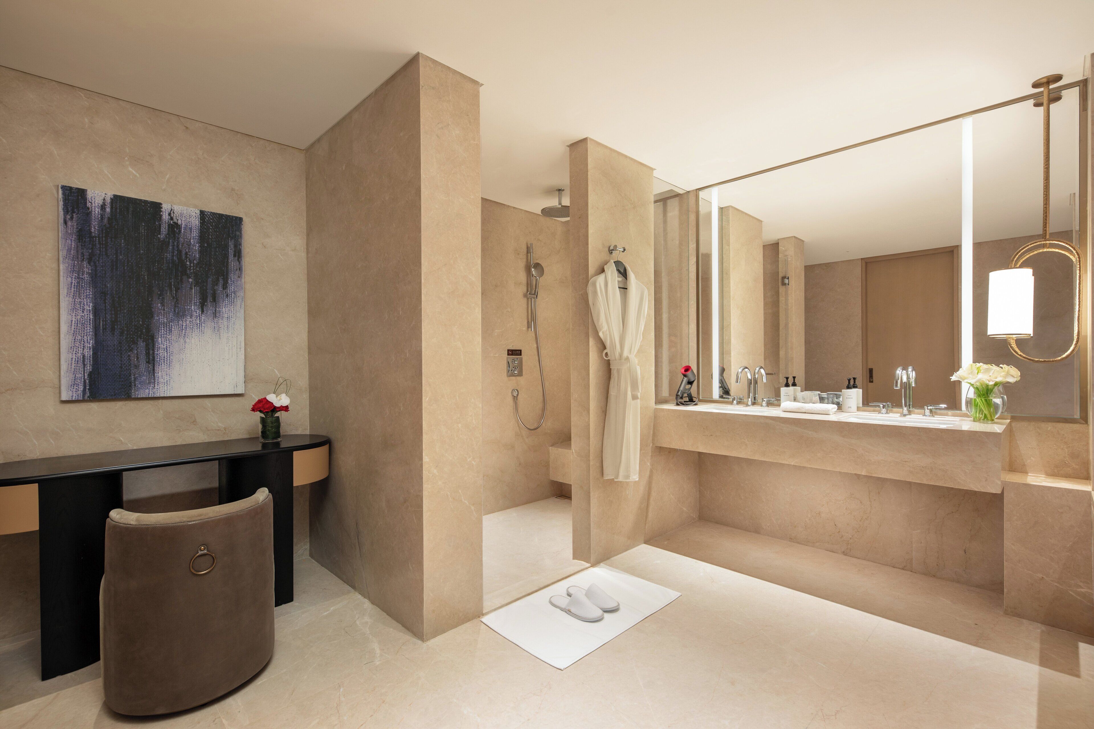 A modern bathroom with a large mirror, a bathtub, and a vanity with a sink.