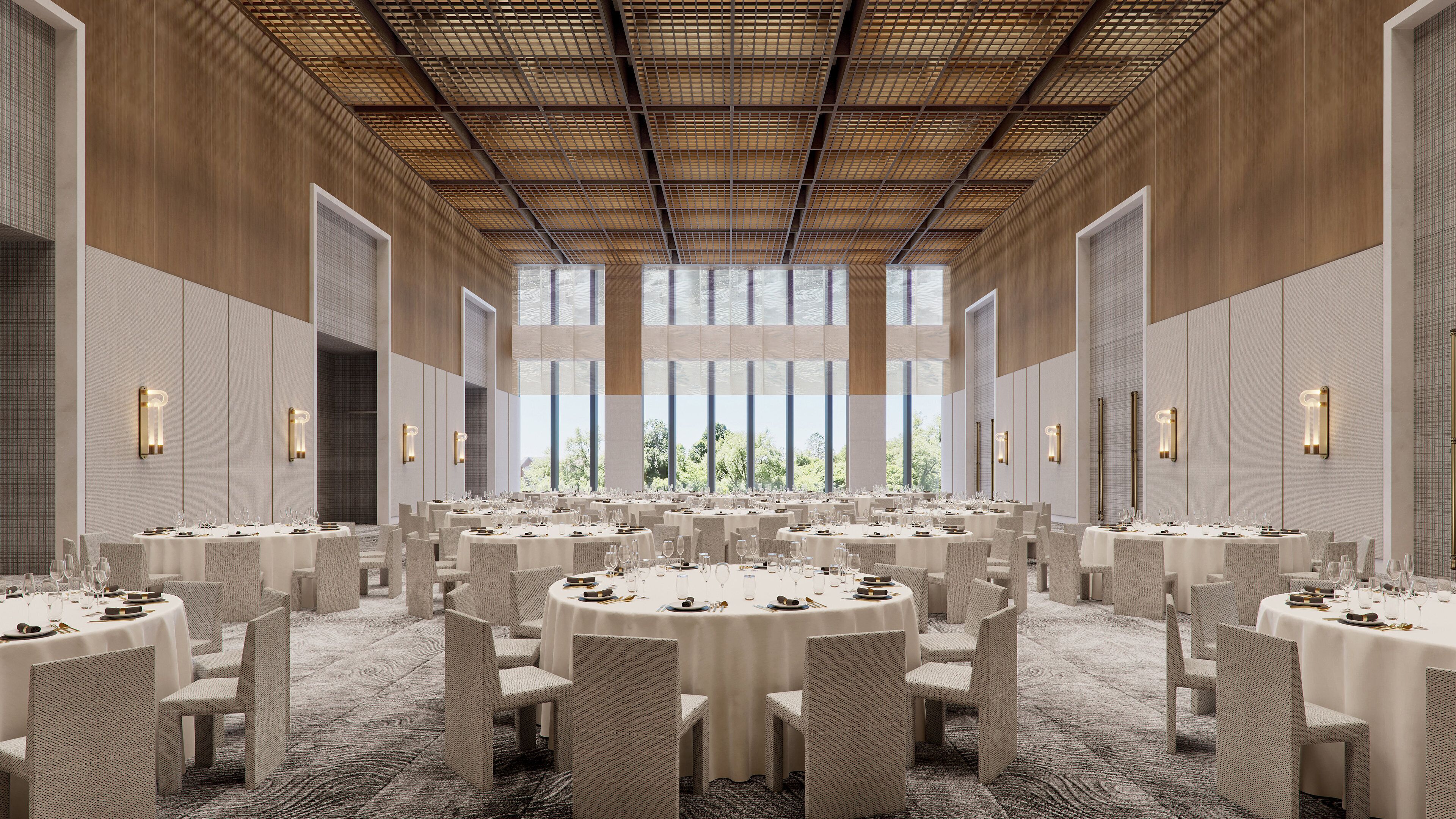A spacious conference room with round tables, chairs, and large windows offering a view of greenery.