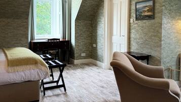 Un dormitorio con cama, escritorio, silla, lámpara y ventana.