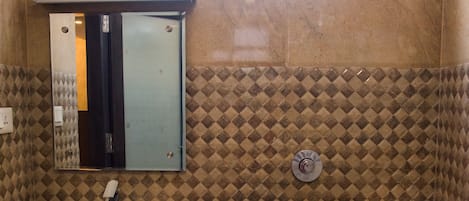 Ein Badezimmer mit Waschbecken, Spiegel, Toilette und einem Fenster über der Toilette.